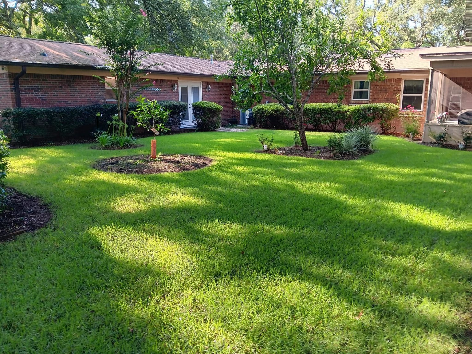 Actual Ohana Quality Services lawn and landscape maintenance at a Northwest Florida home